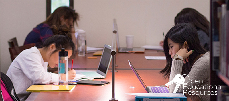 UCI students working on laptops in the library