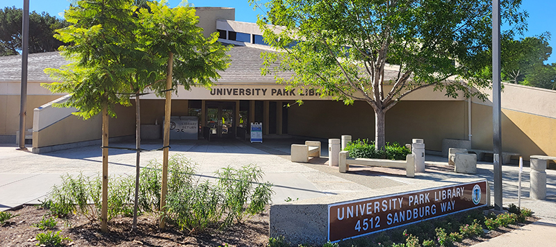 Trees and signage in front of University Park Library branch