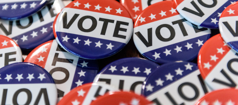 A pile of vote buttons in red, white, and blue